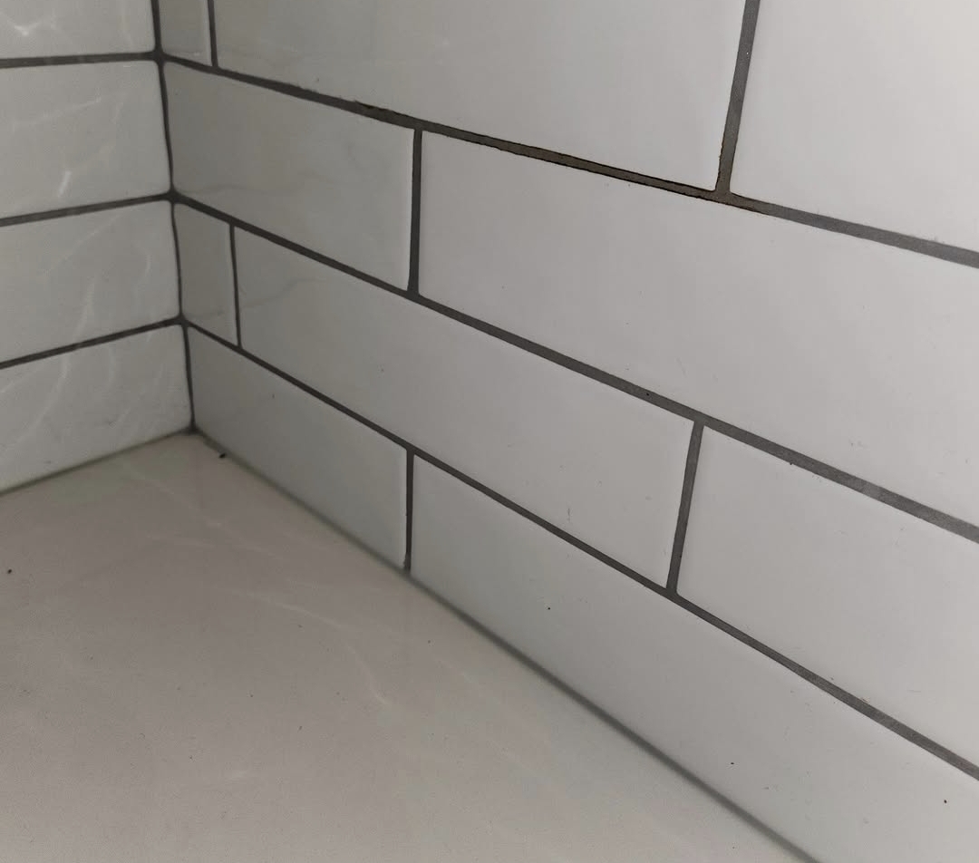 Same subway tile shower corner spotless and stain-free after cleaning