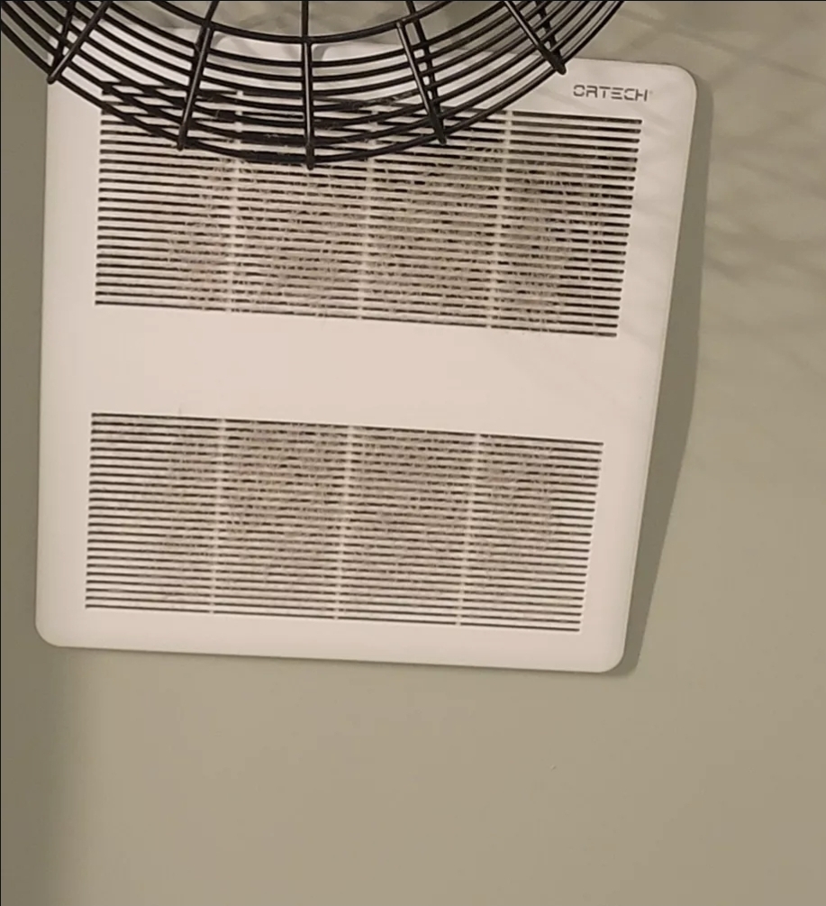 Tile wall with brown stains and grime before cleaning